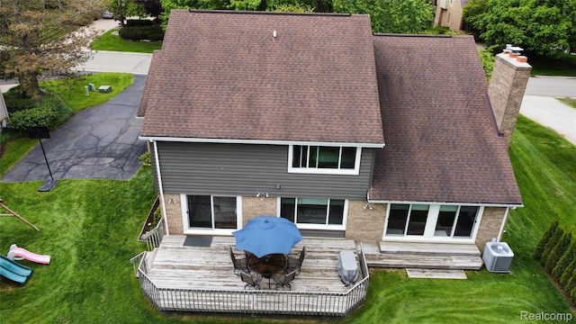 5084 Champlain Cir W, Bloomfield, MI 48323 - rear view of property featuring brick siding, a chimney, a deck, a shingled roof, and a yard