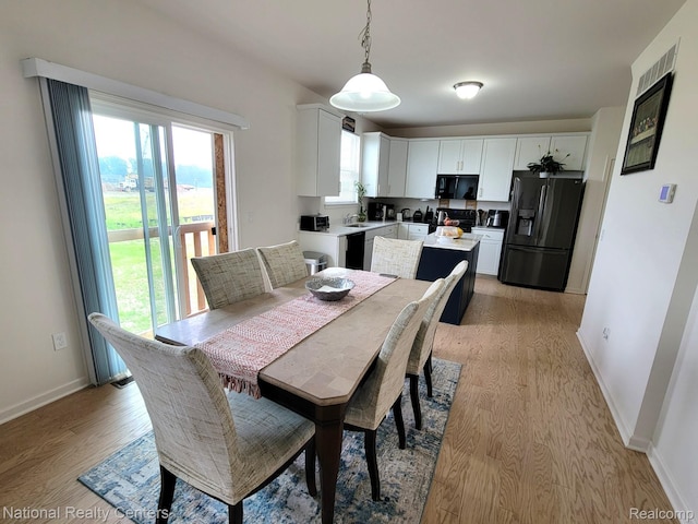 51485 Maple Leaf Dr, Macomb, MI 48042 - dining room with light wood-type flooring and baseboards