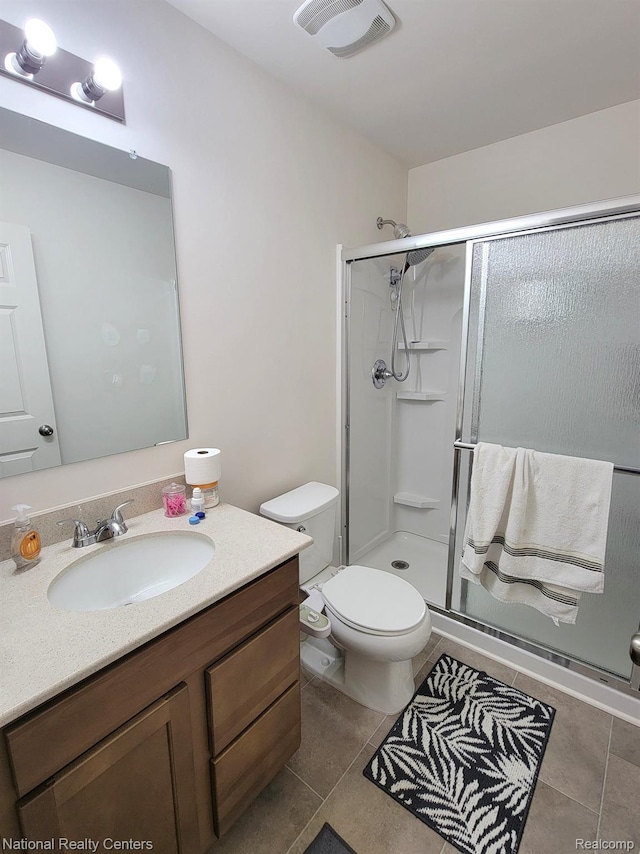 51485 Maple Leaf Dr, Macomb, MI 48042 - full bath with a stall shower, tile patterned floors, vanity, and toilet