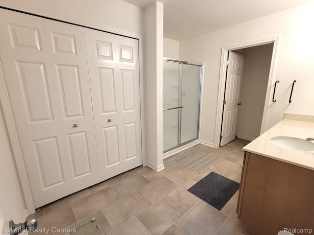 51485 Maple Leaf Dr, Macomb, MI 48042 - bathroom featuring a stall shower, vanity, baseboards, and tile patterned floors