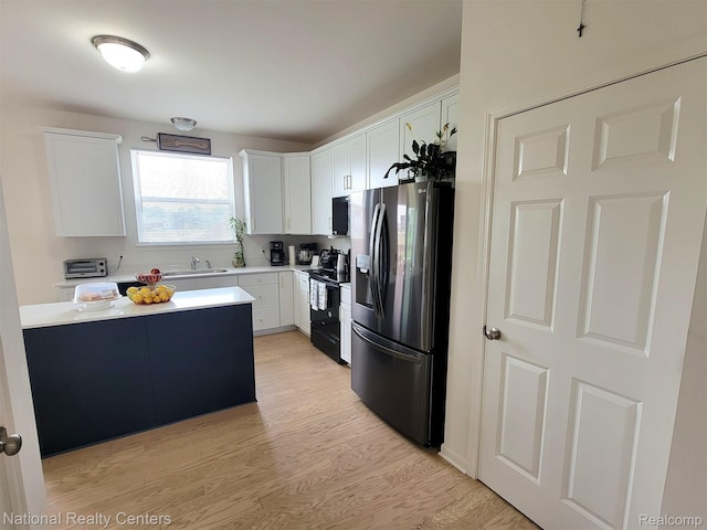 51485 Maple Leaf Dr, Macomb, MI 48042 - kitchen featuring refrigerator with ice dispenser, black electric range, light wood-style flooring, white cabinetry, and light countertops
