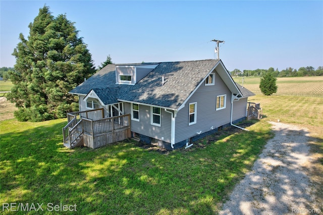 4470 N Lake Rd, Columbiaville, MI 48421 - rear view of property featuring a deck, a shingled roof, and a lawn