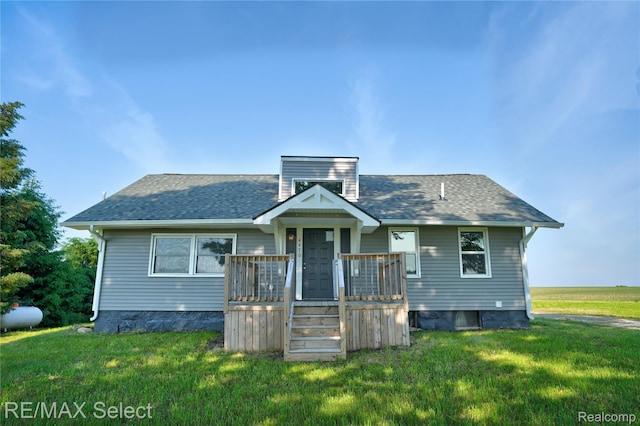 4470 N Lake Rd, Columbiaville, MI 48421 - bungalow with a front lawn, a shingled roof, and a deck