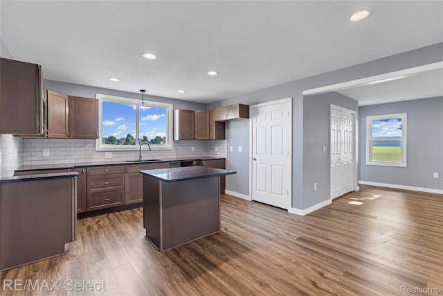 4470 N Lake Rd, Columbiaville, MI 48421 - kitchen featuring dark wood-type flooring, tasteful backsplash, a kitchen island, recessed lighting, and hanging light fixtures