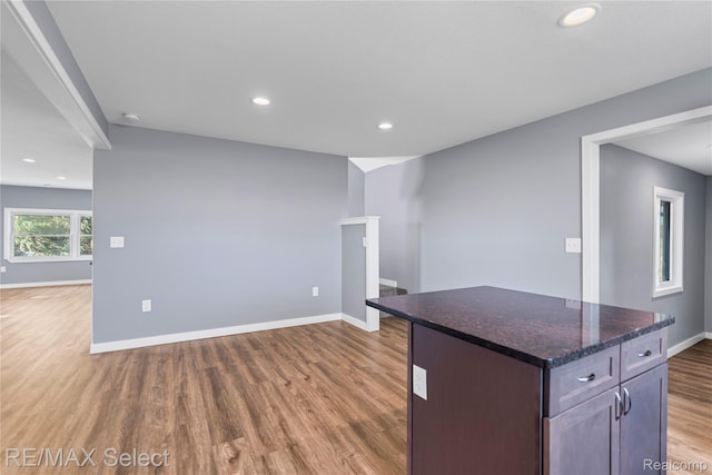 4470 N Lake Rd, Columbiaville, MI 48421 - kitchen with wood finished floors, recessed lighting, a center island, open floor plan, and dark stone countertops