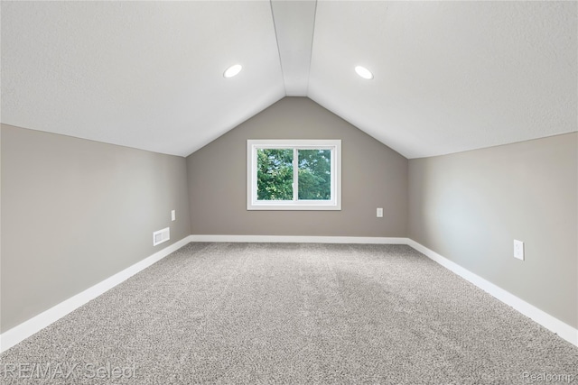4470 N Lake Rd, Columbiaville, MI 48421 - additional living space featuring lofted ceiling, carpet flooring, and recessed lighting