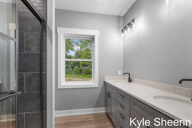 8060 Hunters Xing, Kalamazoo, MI 49009 - full bath with double vanity, wood finished floors, baseboards, and a shower