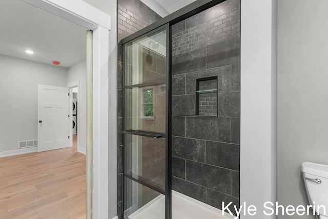 8060 Hunters Xing, Kalamazoo, MI 49009 - full bath with wood finished floors, a stall shower, toilet, and baseboards