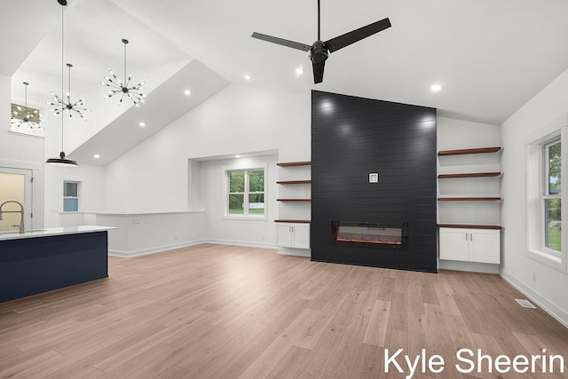 8060 Hunters Xing, Kalamazoo, MI 49009 - unfurnished living room with a sink, a fireplace, high vaulted ceiling, light wood-style floors, and plenty of natural light