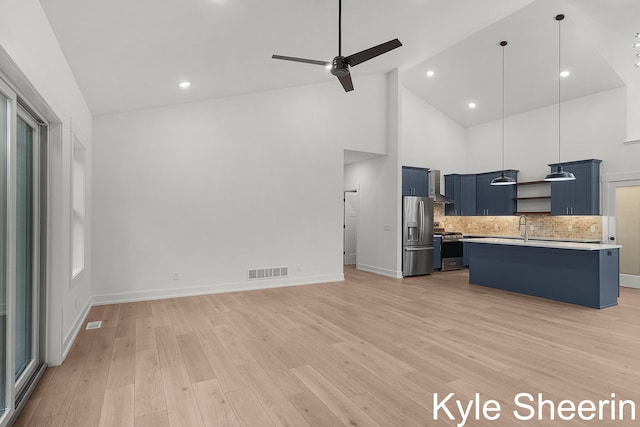 8060 Hunters Xing, Kalamazoo, MI 49009 - kitchen featuring blue cabinets, stainless steel appliances, open shelves, light countertops, and backsplash