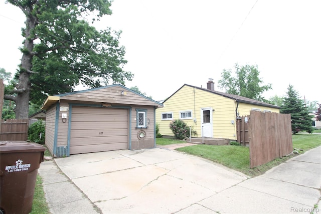 34813 John St, Wayne, MI 48184 - view of front of property with driveway, a garage, and an outbuilding