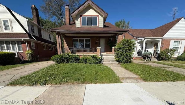3975 Chatsworth St, Detroit, MI 48224 - view of front of home featuring a porch, a front lawn, brick siding, and a chimney