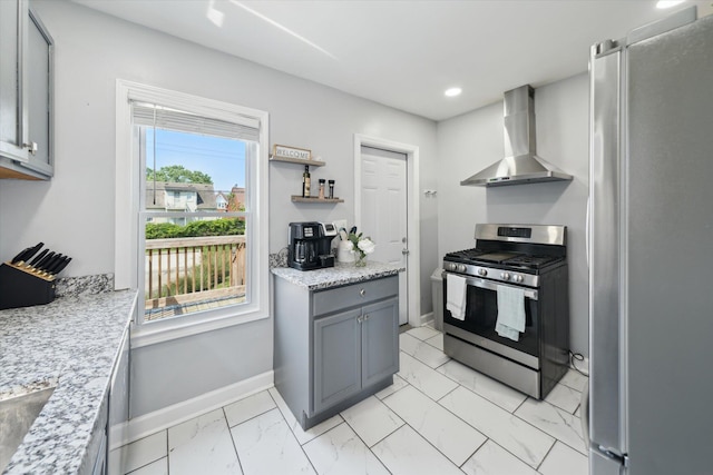 289 Newport St, Detroit, MI 48215 - kitchen with wall chimney range hood, appliances with stainless steel finishes, light marble finish flooring, baseboards, and gray cabinetry