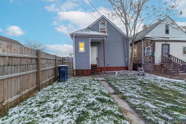 11620 Nagel St, Hamtramck, MI 48212 - snow covered rear of property with entry steps and a fenced backyard