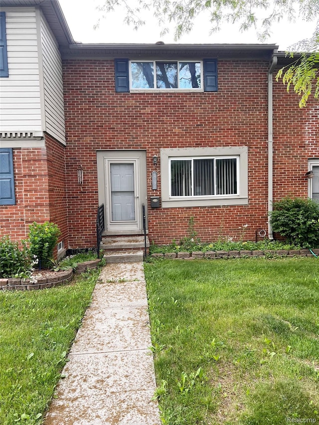 25731 Salem Ct Unit 63, Roseville, MI 48066 - view of property featuring brick siding and a front lawn
