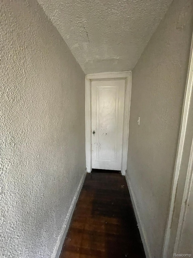 15395 Littlefield St, Detroit, MI 48227 - hallway with baseboards, a textured wall, a textured ceiling, and wood finished floors