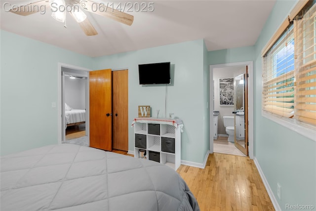5388 N Georgetown Rd, Grand Blanc, MI 48439 - bedroom with wood finished floors, connected bathroom, a closet, and a ceiling fan