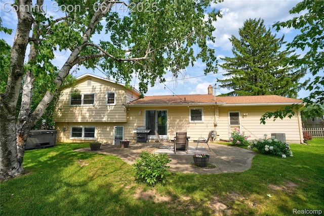 5388 N Georgetown Rd, Grand Blanc, MI 48439 - rear view of property with a patio area, a lawn, a hot tub, and a chimney