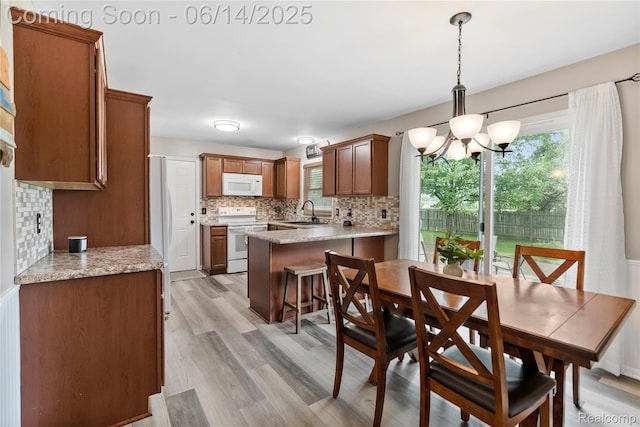 5388 N Georgetown Rd, Grand Blanc, MI 48439 - dining space with a chandelier and light wood-type flooring