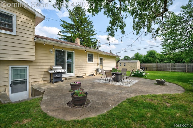 5388 N Georgetown Rd, Grand Blanc, MI 48439 - fenced backyard featuring a patio, a storage shed, and a grill