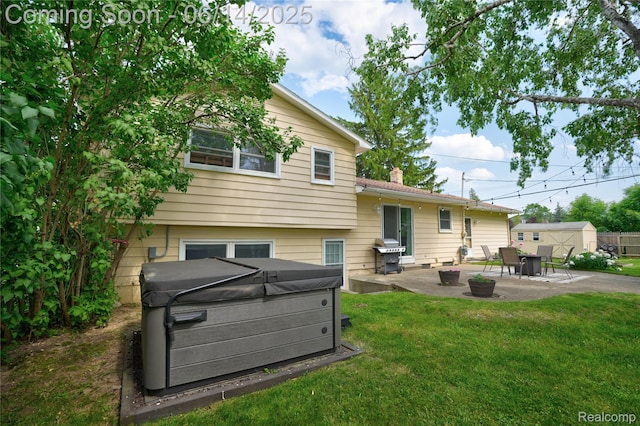 5388 N Georgetown Rd, Grand Blanc, MI 48439 - rear view of house with a hot tub, a patio area, a lawn, and a chimney