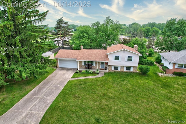 5388 N Georgetown Rd, Grand Blanc, MI 48439 - split level home featuring a chimney, driveway, a garage, a front yard, and brick siding