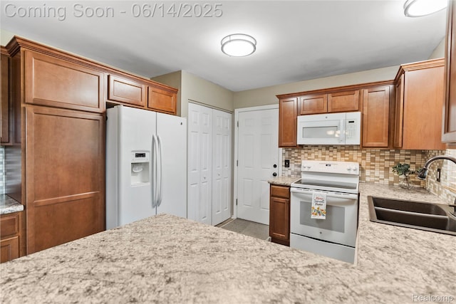 5388 N Georgetown Rd, Grand Blanc, MI 48439 - kitchen featuring white appliances, backsplash, and brown cabinetry