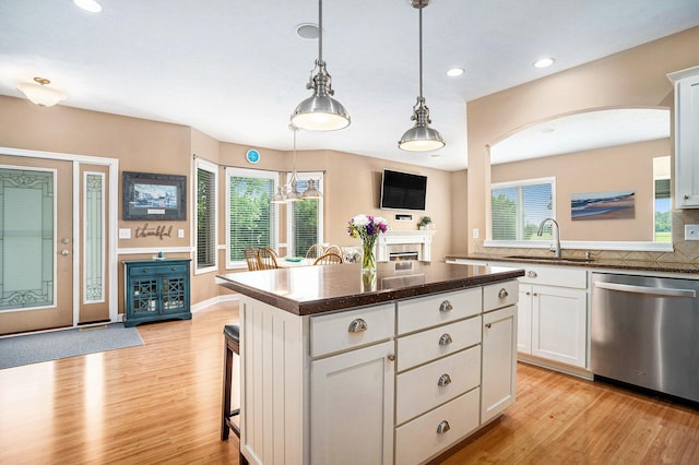 1300 St Andrews Dr, Holland, MI 49423 - kitchen with stainless steel dishwasher, a sink, light wood-type flooring, healthy amount of natural light, and recessed lighting
