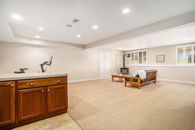 1300 St Andrews Dr, Holland, MI 49423 - living area featuring a wood stove, baseboards, healthy amount of natural light, and recessed lighting