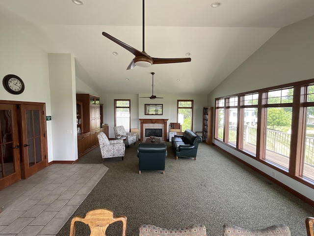 1300 St Andrews Dr, Holland, MI 49423 - carpeted living area featuring ceiling fan, a tiled fireplace, high vaulted ceiling, french doors, and recessed lighting