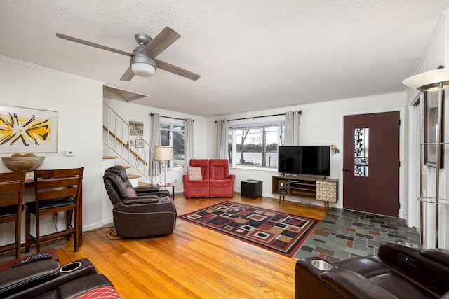 114 W Grove Ave, Michigan Center, MI 49254 - living area featuring wood finished floors, a textured ceiling, a ceiling fan, and stairs