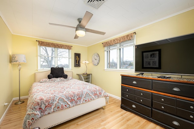 114 W Grove Ave, Michigan Center, MI 49254 - bedroom with crown molding, multiple windows, light wood finished floors, baseboards, and ceiling fan