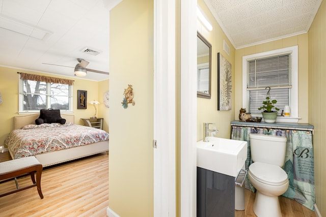 114 W Grove Ave, Michigan Center, MI 49254 - bedroom featuring wood finished floors, crown molding, a sink, and a ceiling fan