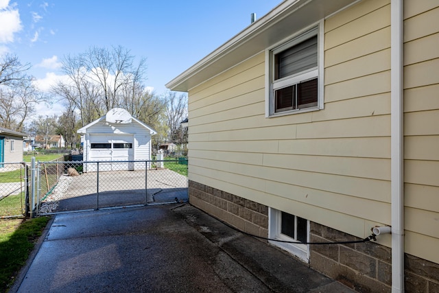 114 W Grove Ave, Michigan Center, MI 49254 - view of side of property with driveway, a garage, and an outdoor structure
