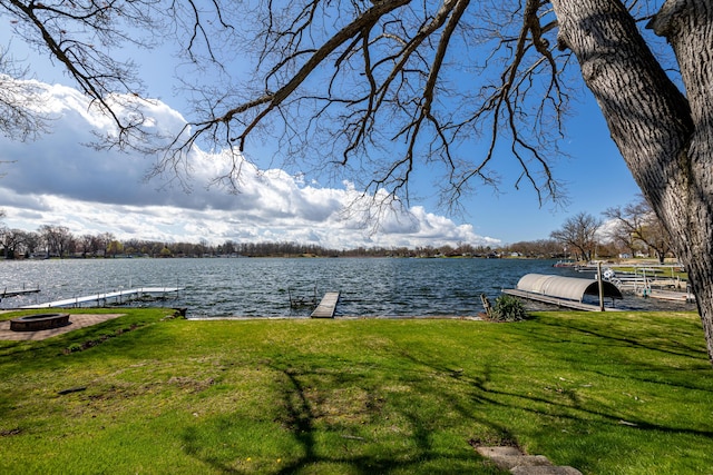 114 W Grove Ave, Michigan Center, MI 49254 - dock area featuring a water view, a lawn, and an outdoor fire pit