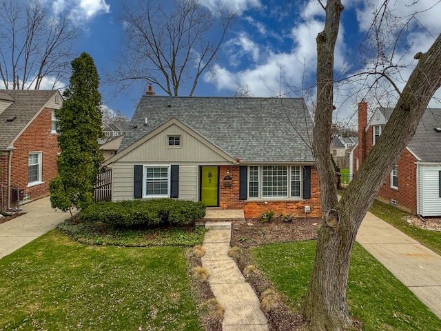 4422 Groveland Ave, Royal Oak, MI 48073 - view of front of property with brick siding, a front lawn, roof with shingles, and board and batten siding