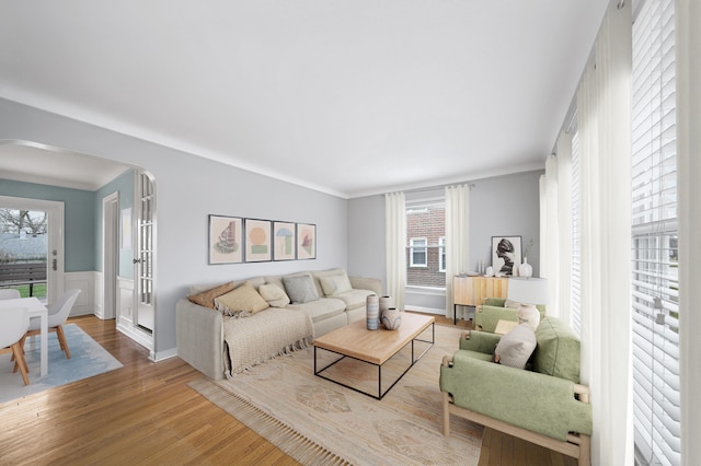 4422 Groveland Ave, Royal Oak, MI 48073 - living room with arched walkways, wood finished floors, plenty of natural light, and wainscoting