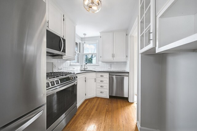 4422 Groveland Ave, Royal Oak, MI 48073 - kitchen featuring stainless steel appliances, a sink, white cabinetry, and decorative backsplash