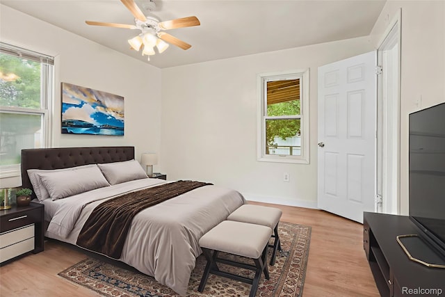 1496 E Parkwood Ave, Burton, MI 48529 - bedroom featuring multiple windows, light wood-type flooring, and a ceiling fan