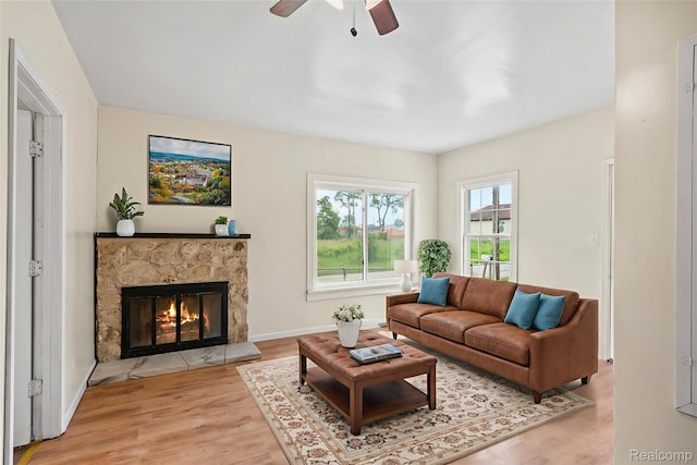 1496 E Parkwood Ave, Burton, MI 48529 - living room featuring wood finished floors, a ceiling fan, and a glass covered fireplace