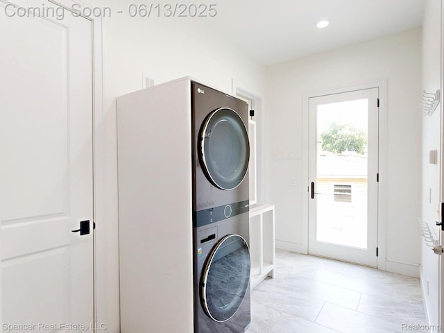 571 Dunleavy Dr, Highland, MI 48356 - laundry area with stacked washer / drying machine, recessed lighting, and baseboards