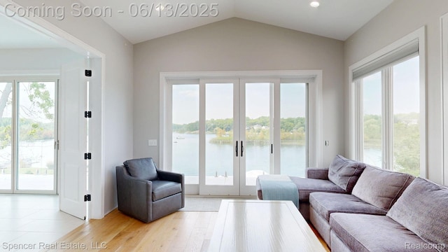571 Dunleavy Dr, Highland, MI 48356 - living room with a water view, lofted ceiling, light wood-type flooring, french doors, and recessed lighting