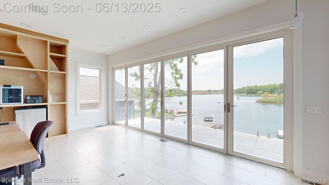 571 Dunleavy Dr, Highland, MI 48356 - home office with a water view, baseboards, light tile patterned floors, and built in shelves