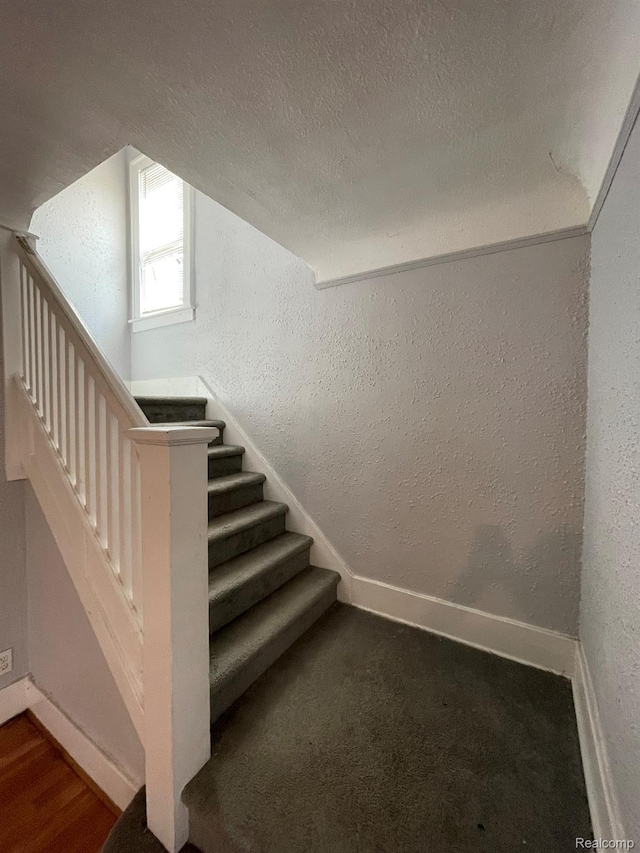 4368 Buckingham Ave, Detroit, MI 48224 - staircase with a textured wall, baseboards, and a textured ceiling