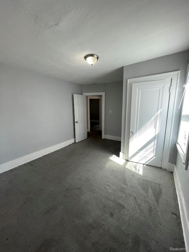 4368 Buckingham Ave, Detroit, MI 48224 - unfurnished room featuring carpet, baseboards, and a textured ceiling