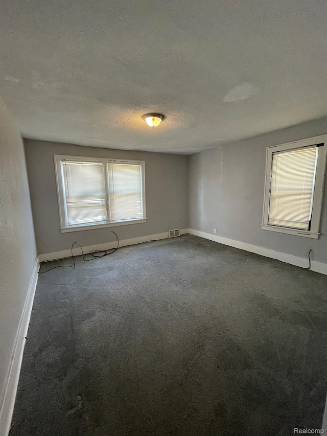 4368 Buckingham Ave, Detroit, MI 48224 - carpeted spare room with baseboards and a textured ceiling