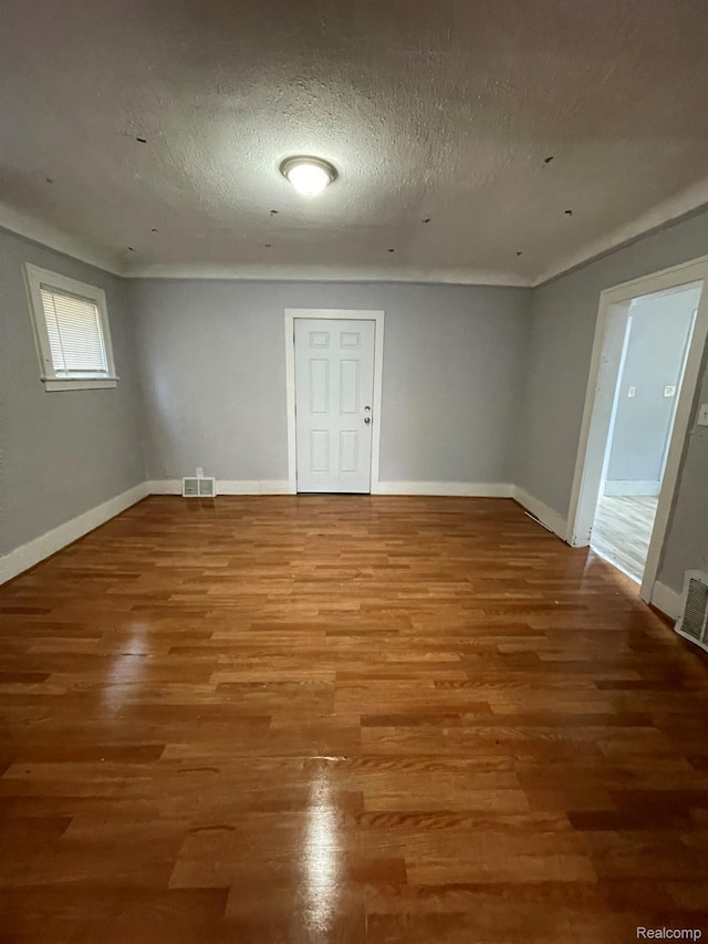 4368 Buckingham Ave, Detroit, MI 48224 - unfurnished room featuring wood finished floors, baseboards, and a textured ceiling