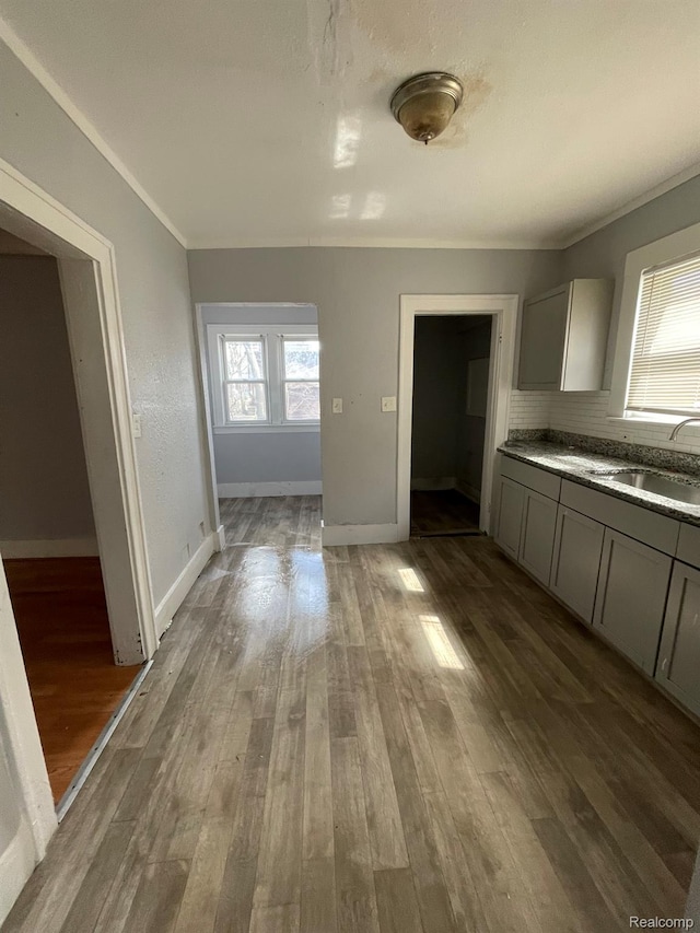 4368 Buckingham Ave, Detroit, MI 48224 - kitchen featuring a sink, gray cabinets, wood finished floors, ornamental molding, and baseboards