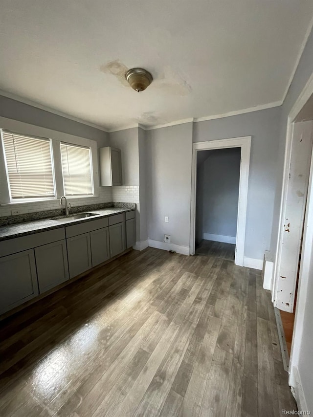 4368 Buckingham Ave, Detroit, MI 48224 - kitchen with a sink, gray cabinets, ornamental molding, wood finished floors, and baseboards