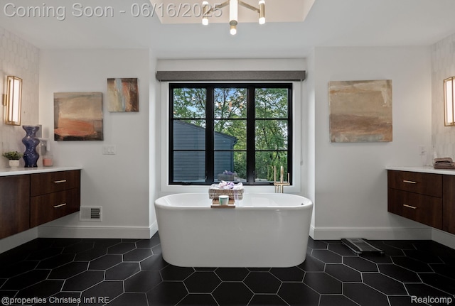 1044 Hazel, Birmingham, MI 48009 - bathroom with vanity, a freestanding tub, tile patterned floors, and a chandelier
